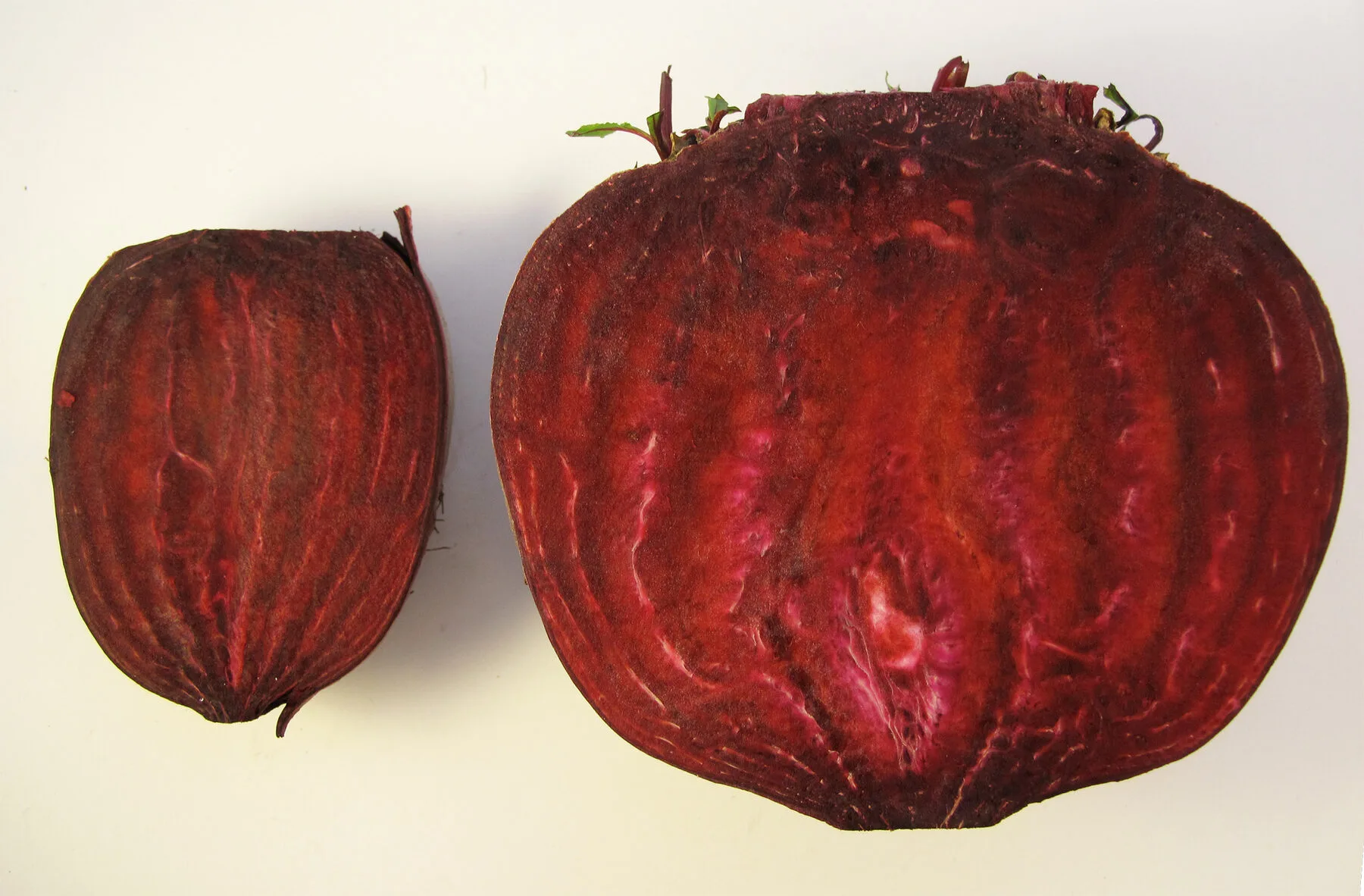 Two halved beetroots with deep red flesh