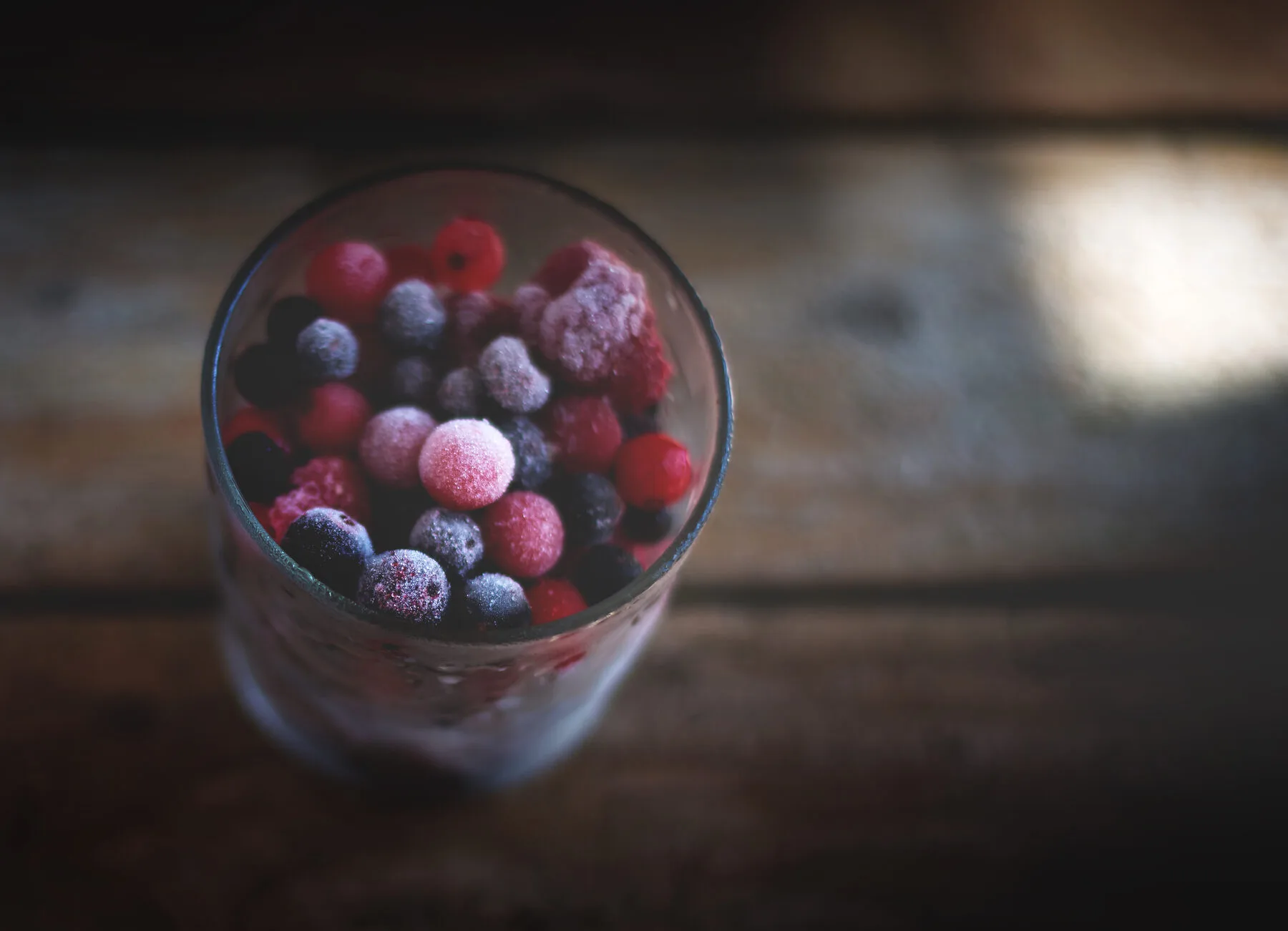 Frozen colourful berries in a glass